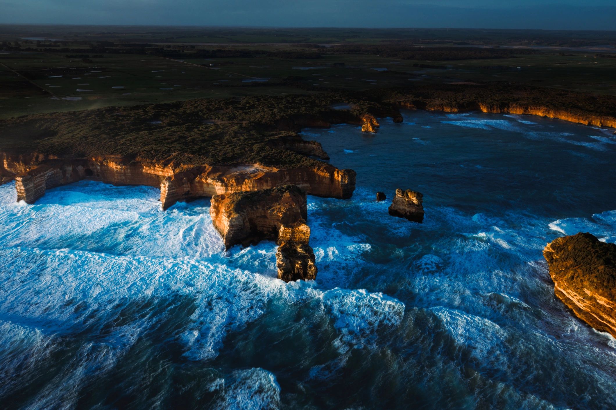Aerial sunset view over dramatic coastal rock formations