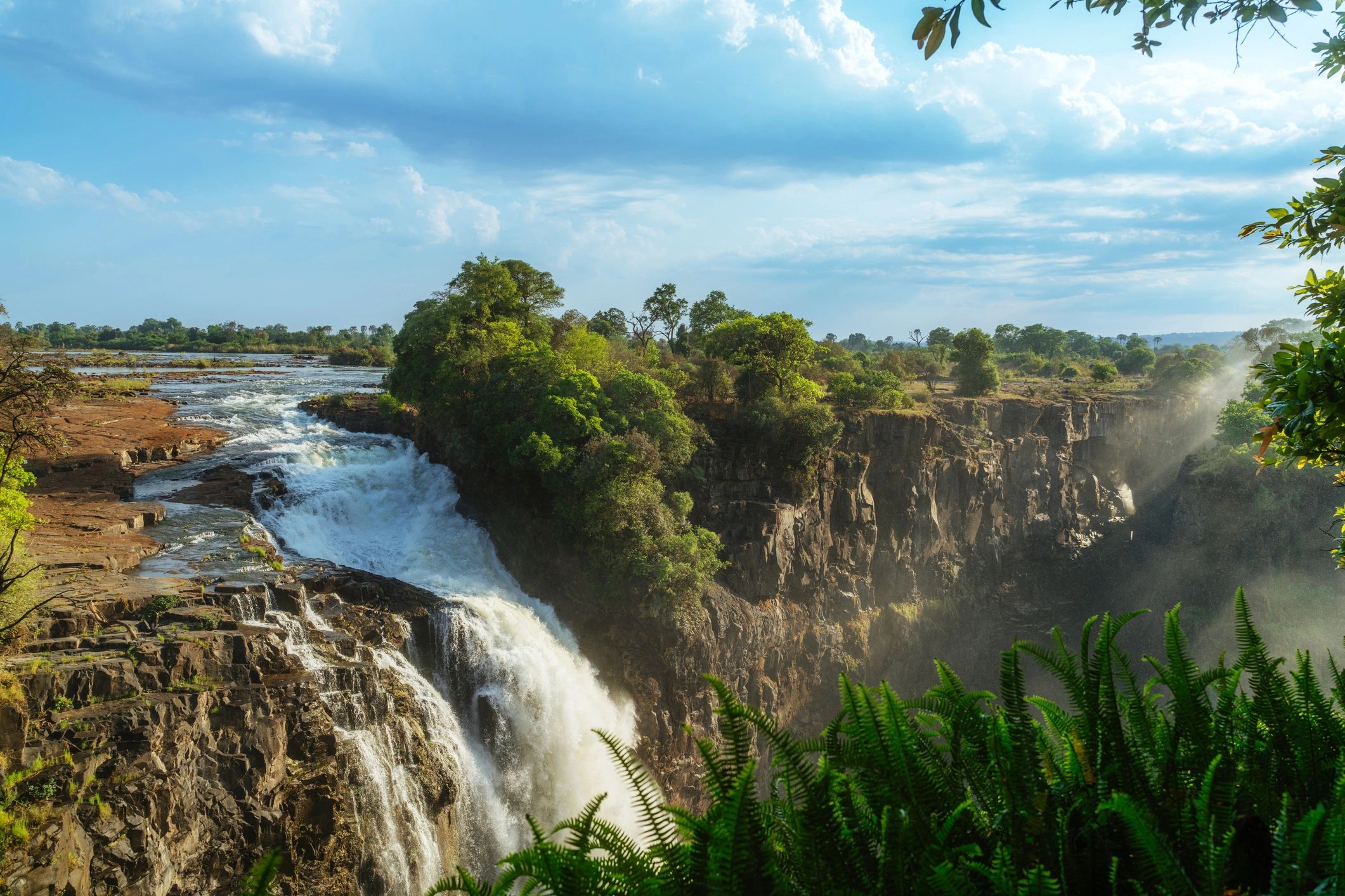 Powerful waterfall flowing over rugged rocks