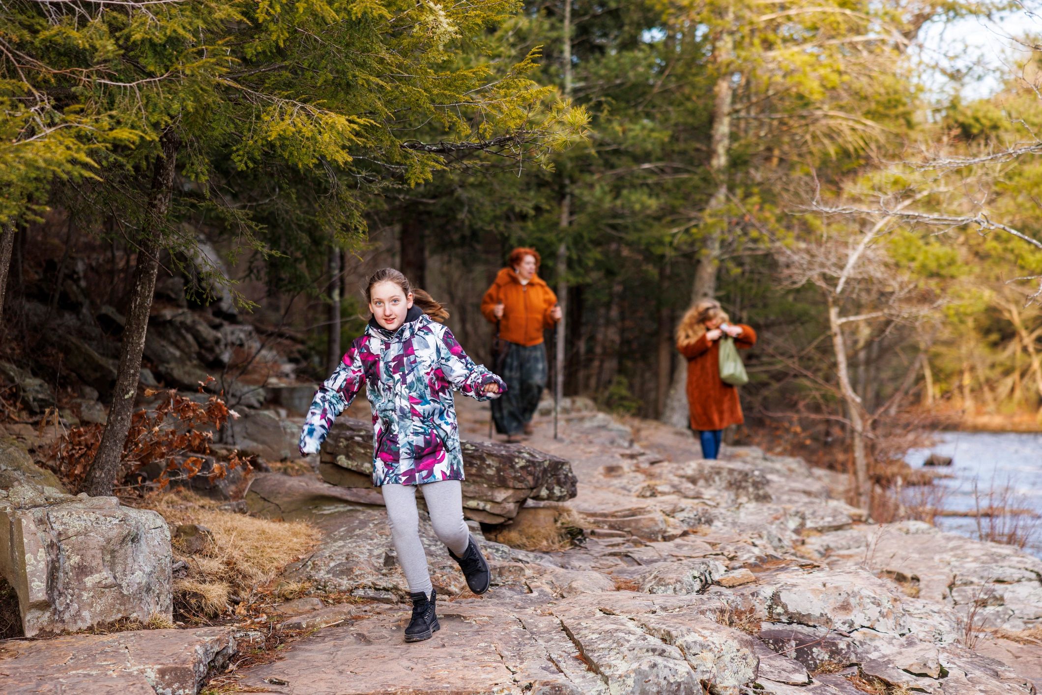Family hiking together on a rocky forest trail